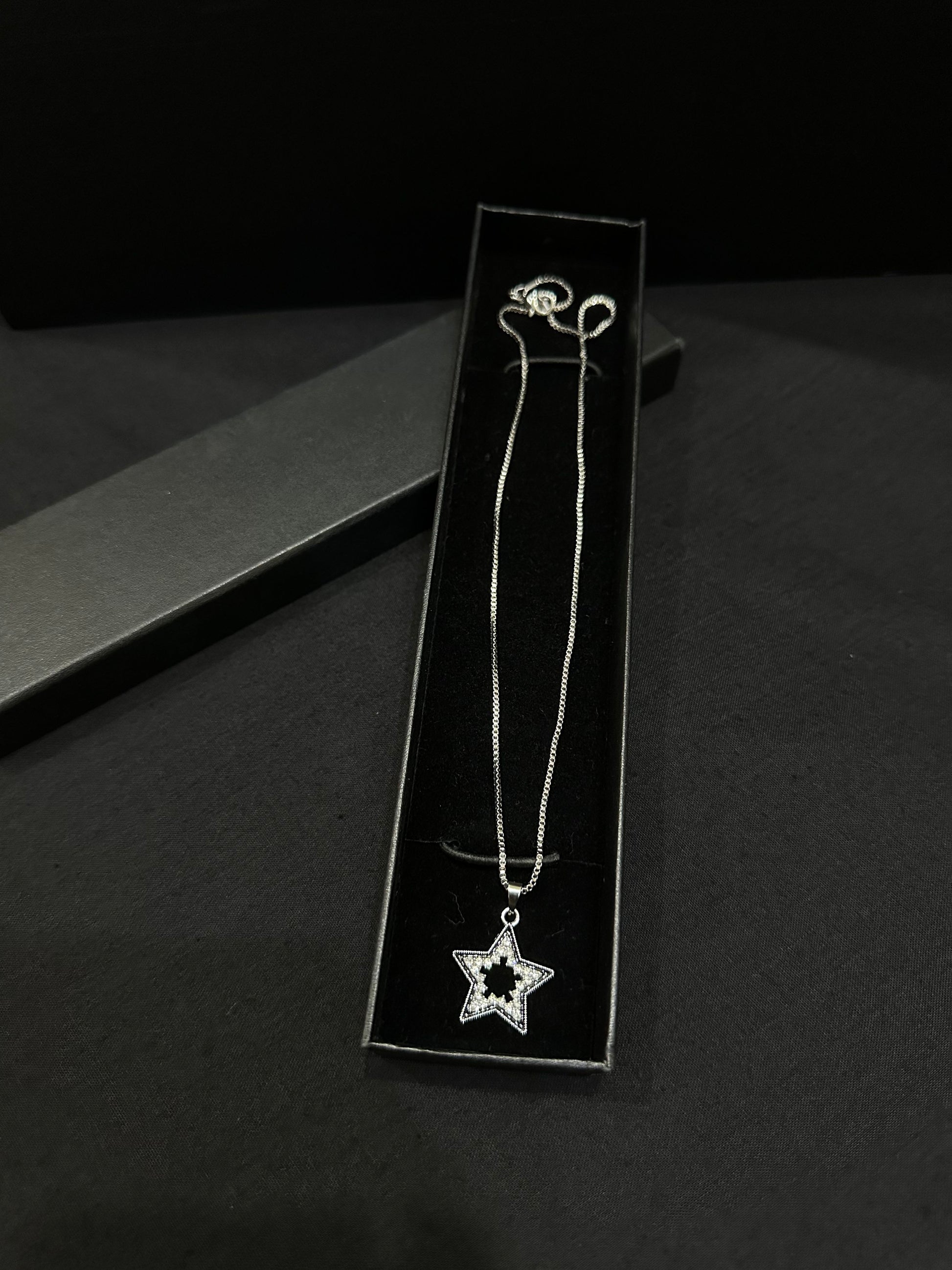 Zyro celestial star pendant featuring a delicate star-shaped charm with intricate details on a fine chain.