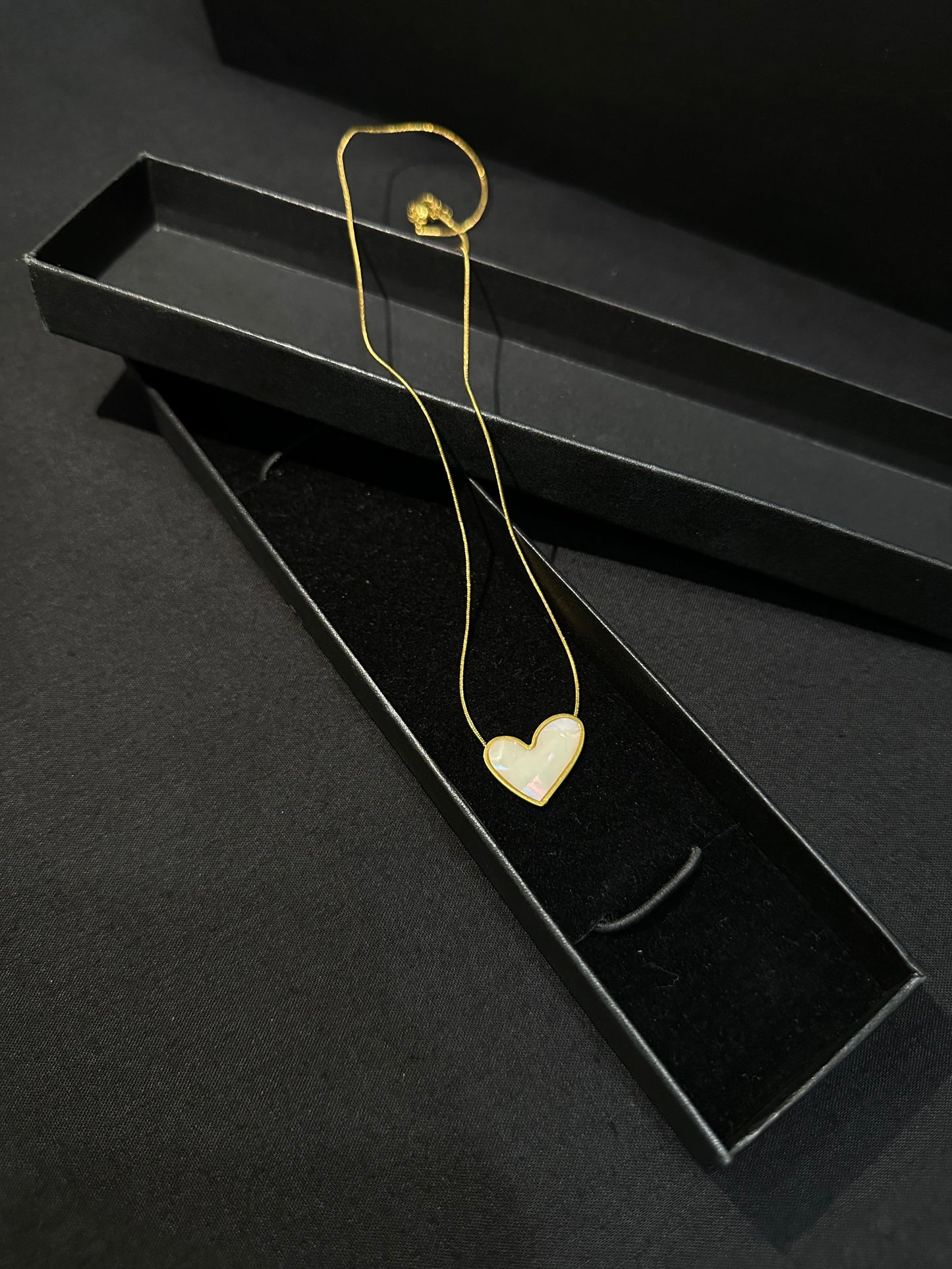 Zyro Luna Heart Pendant in white edition featuring a delicate heart-shaped design on a sleek chain.