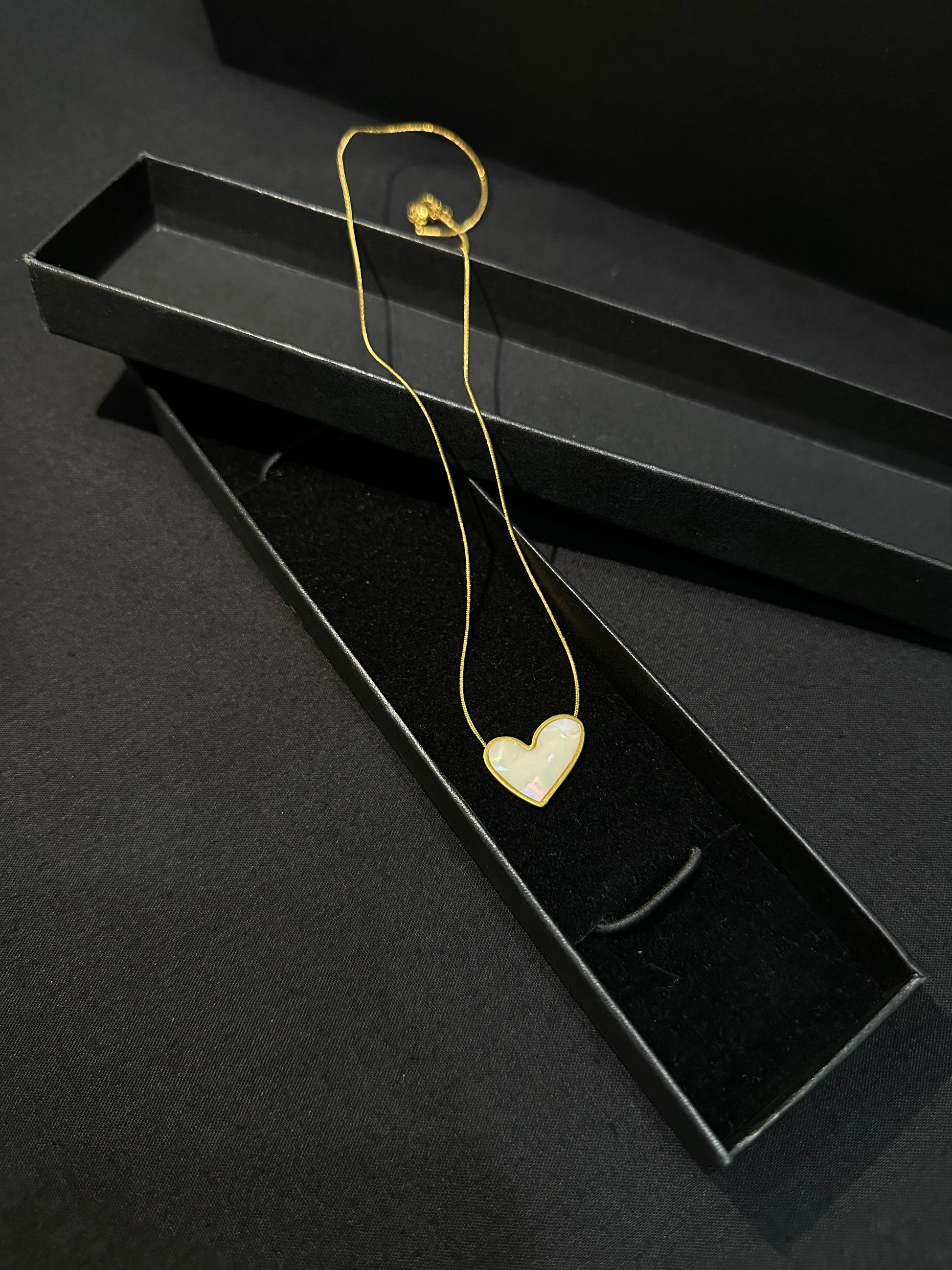 Zyro Luna Heart Pendant in white edition featuring a delicate heart-shaped design on a sleek chain.