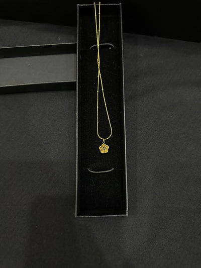 Golden Bloom Pendant by Zyro featuring a detailed floral design on a delicate gold chain.