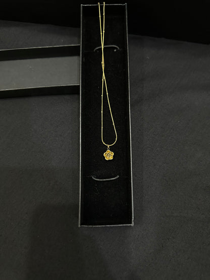 Golden Bloom Pendant by Zyro featuring a detailed floral design on a delicate gold chain.