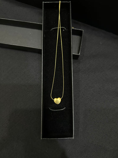 Gold heart pendant by Zyro featuring a polished, elegant design with a delicate chain and a shiny finish.