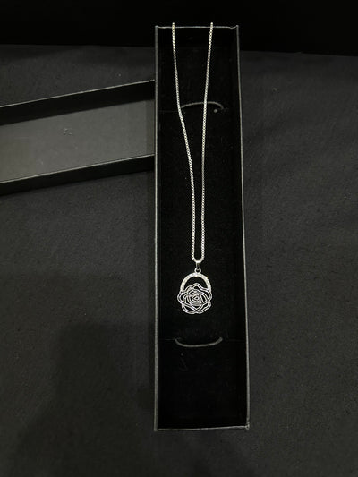 Silver rose pendant by Zyro featuring a detailed, polished rose design on a delicate chain, close-up view.