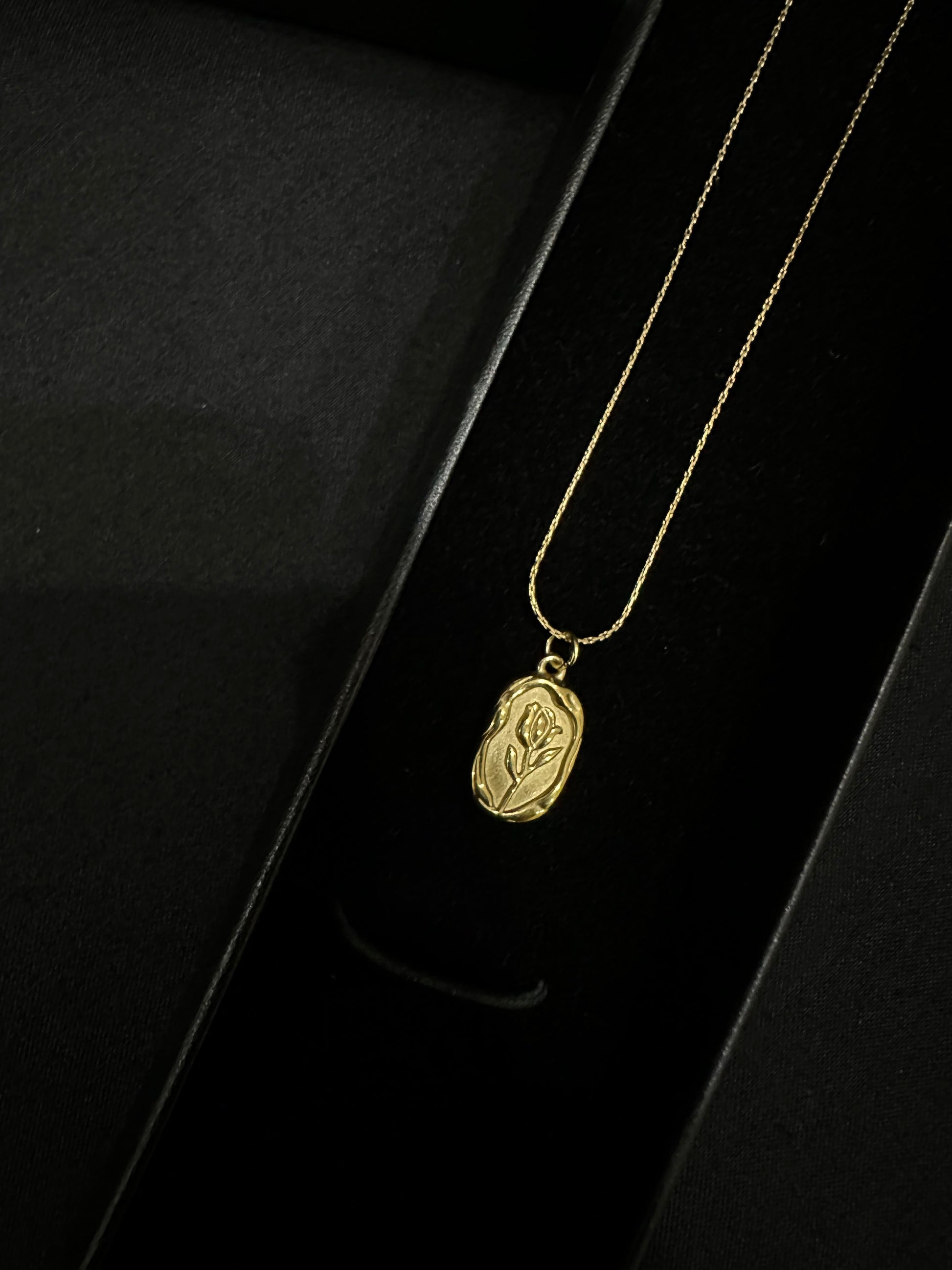 Golden leaf pendant by Zyro featuring a delicate, detailed gold leaf design on a chain.