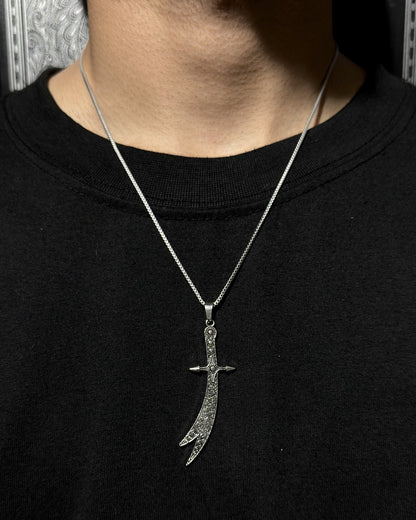 Zulfiqar Sword Pendant in D2 steel by Zyro, featuring intricate design and polished finish, displayed on a black background.